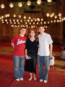 Posing for a photo shoeless. No shoes allowed inside mosques.