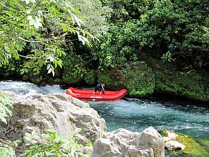 A guide rafting solo through the dangerous part.