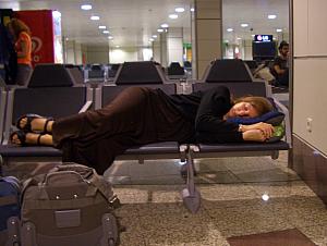 Kelly trying to catch a few zzzs while waiting for our flight.