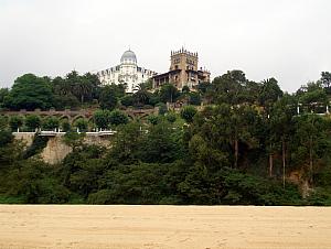 Walking along the beach at Santander, looking towards some old palacial buildings.