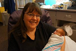 Grandma Larbes gets her first turn to hold Capri!