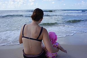 Mommy's turn to sit in the sand with Capri.