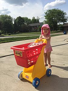 Capri pushing her shopping cart down the drivweay