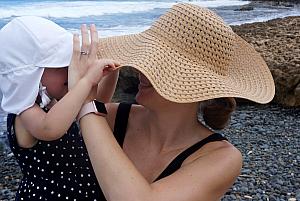 Capri and Mom playing with their hats