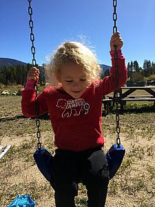 Capri enjoying the swingset near our cabin..