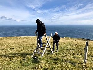 Using the ladder to cross over the wire fence